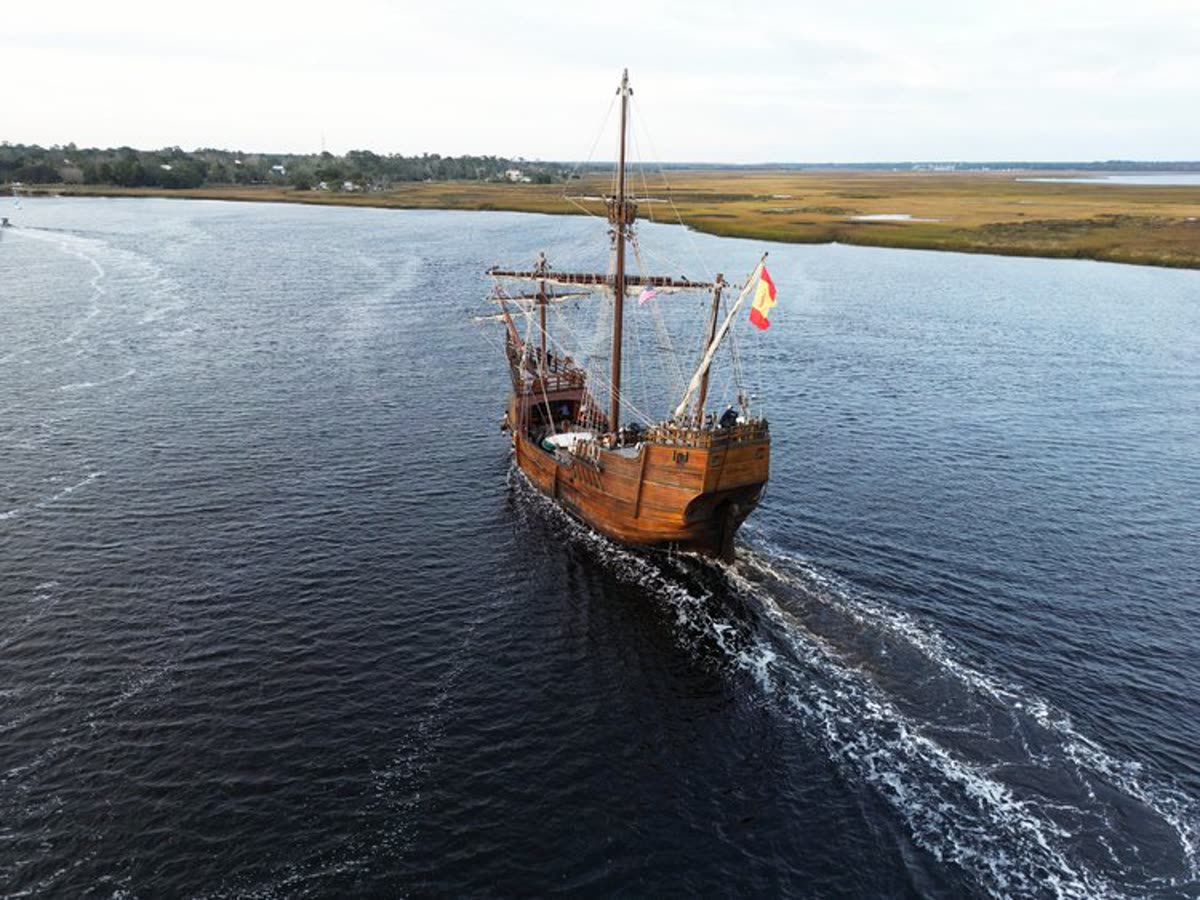 Aerial view of a tall ship sailing the marsh river in Camden County
